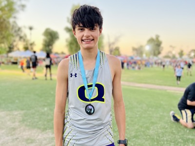 Teen boy smiling and wearing medal