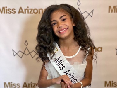 Girl in pageant dress and sash