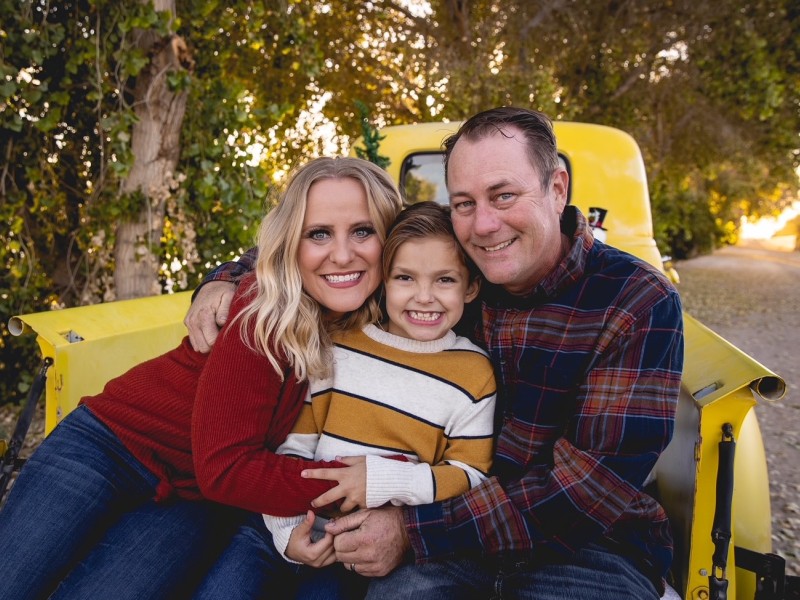 Family sitting in the back of a truck