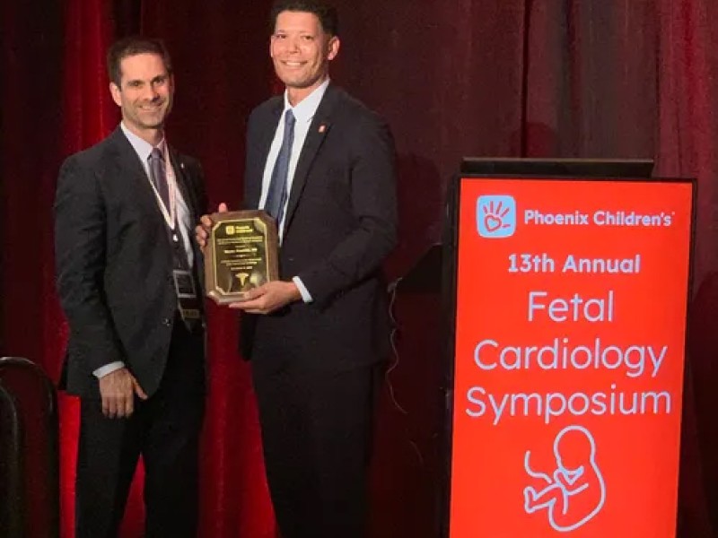 Doctors standing with award