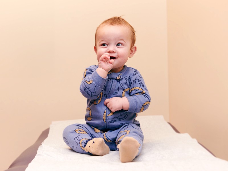 Baby sitting on table smiling