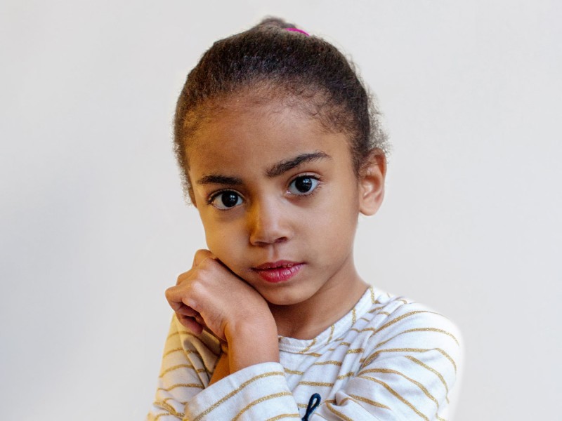 Girl in striped shirt looking at camera