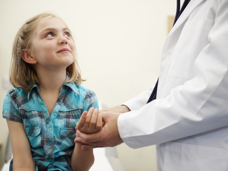 Girl having her wrist checked