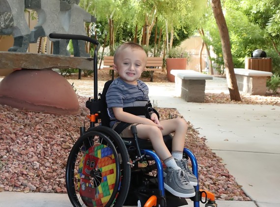 Child in wheelchair outside