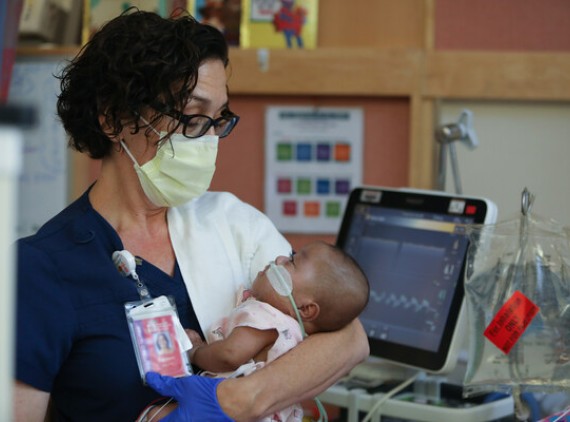NICU nurse holding baby