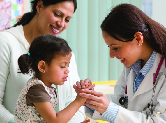 Young girl with doctor and mother