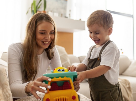 Mother and son playing with toy car