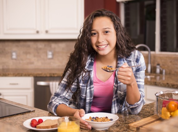 Young female athlete eating healthy breakfast