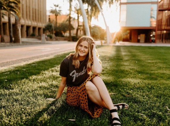 Teen girl sitting in the grass