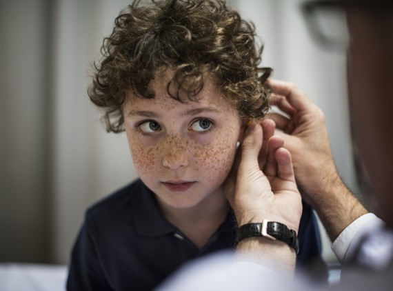 Boy getting his ears checked