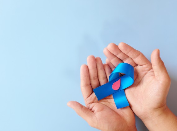 Two hands holding a blue ribbon