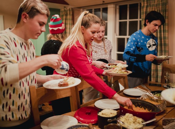 Family filling their plates at buffet table