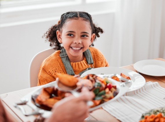 Girl smiling at dinner table