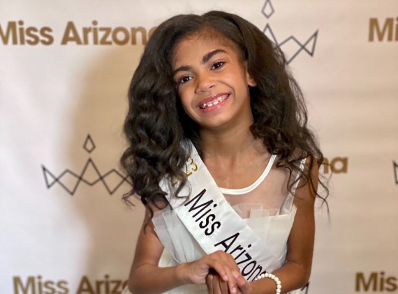 Girl in pageant dress and sash