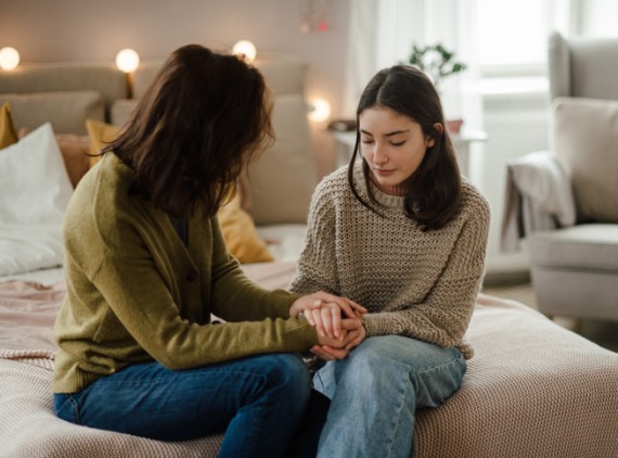 Teen holding mothers hands
