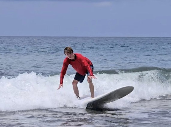 Teen boy surfing