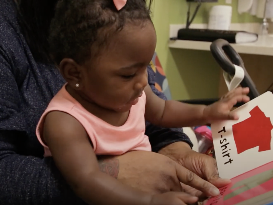 Toddler look at picture in book