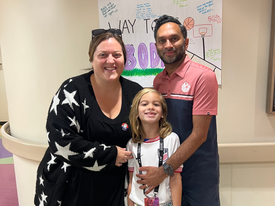 Boy and parents smiling