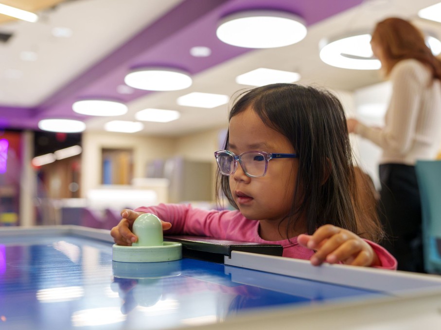 Girl playing air hockey