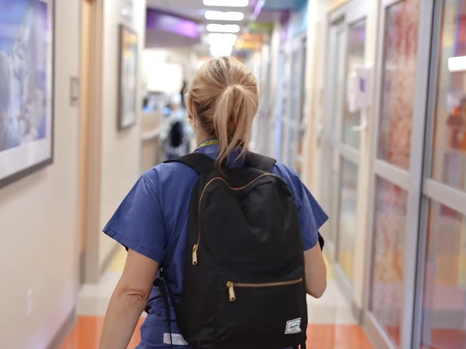 Palliative Care fellow walking through hallway