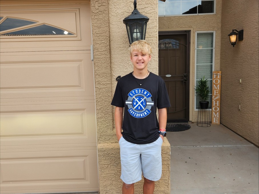 Boy smiling outside of home