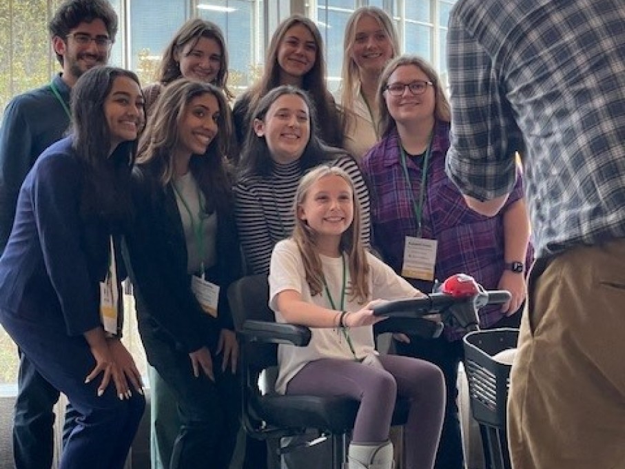 Hospital staff with patient in scooter