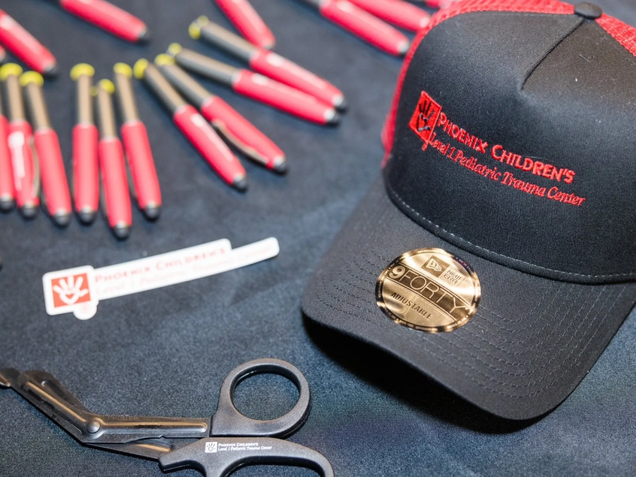 Phoenix Children's branded hat, pens, and scissors