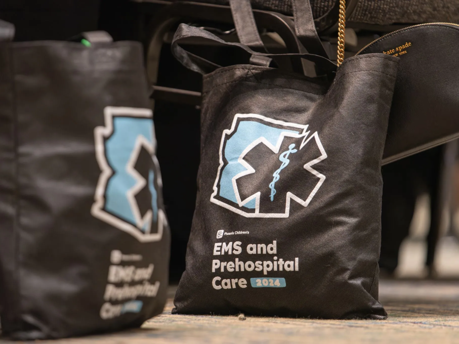 Black tote bags with 2024 EMS Conference logo