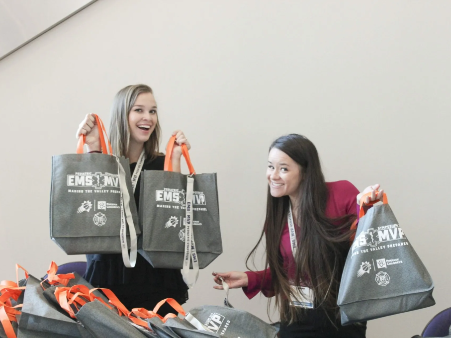Women with EMS tote bags