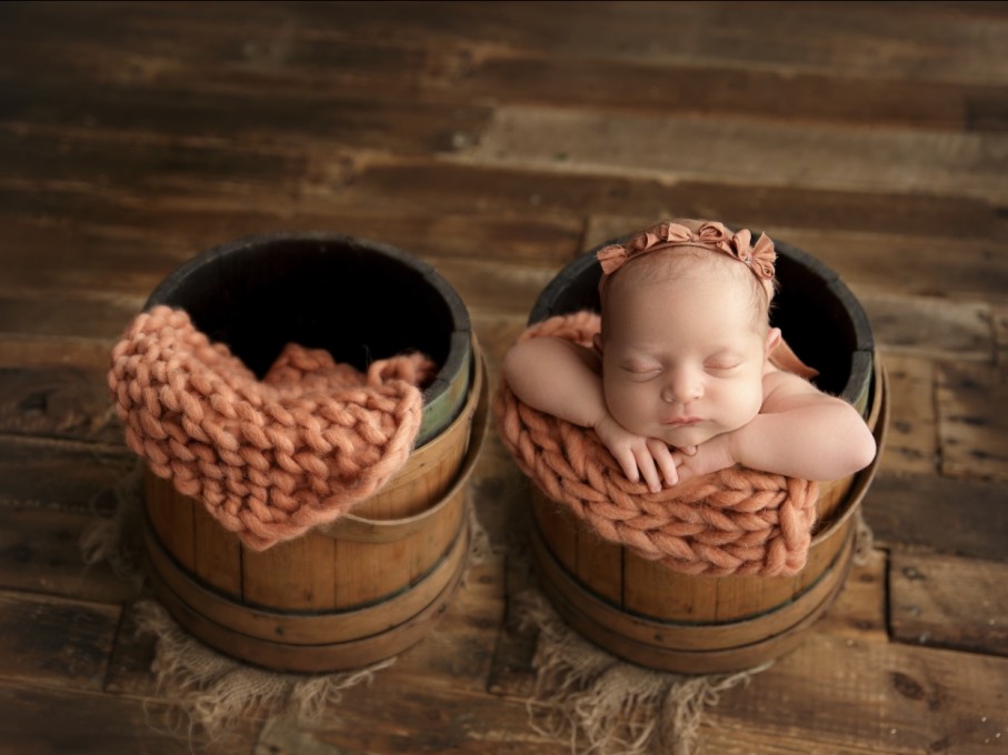 Portrait of an infant in bucket