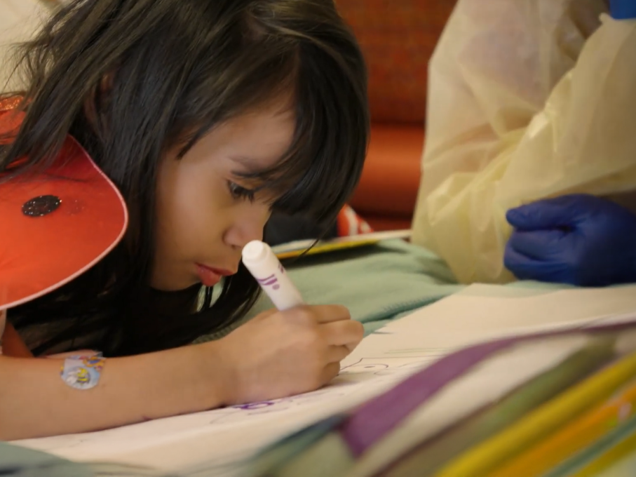 Girl coloring with a marker