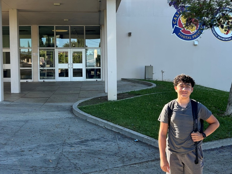 Teen boy smiling outside of  high school