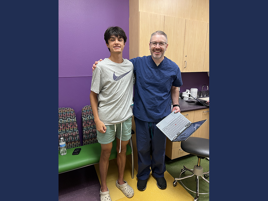 Eli smiling with Dr. David Bennett