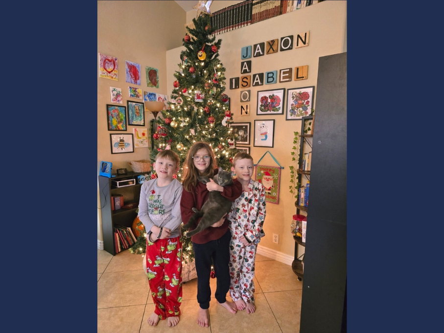 Kids in front of holiday tree