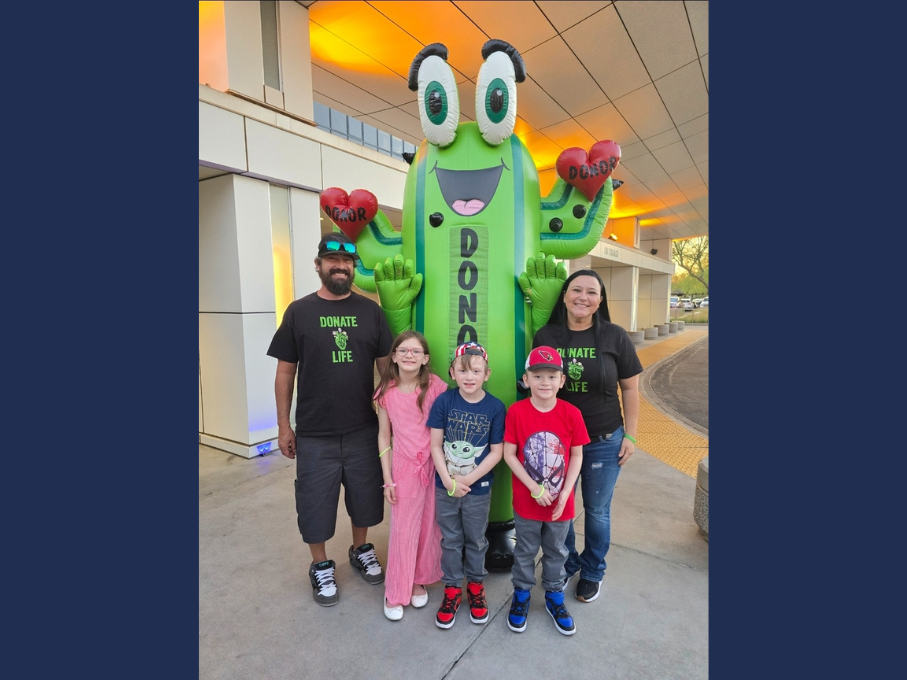 Family in front of inflatable cactus