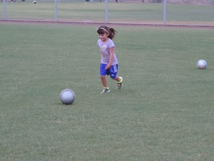 Young girl playing soccer