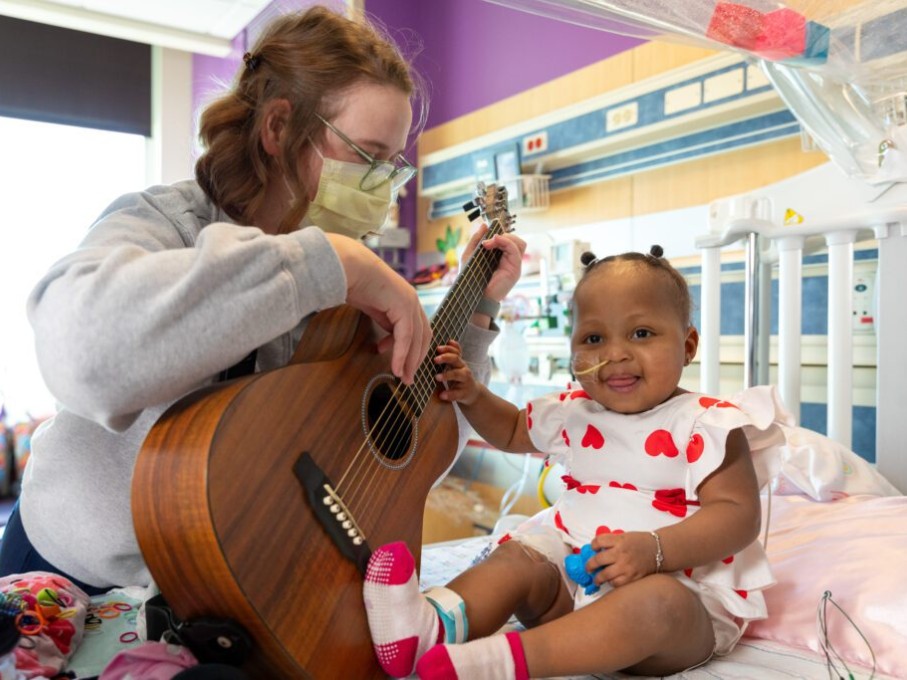 Toddler strumming guitar