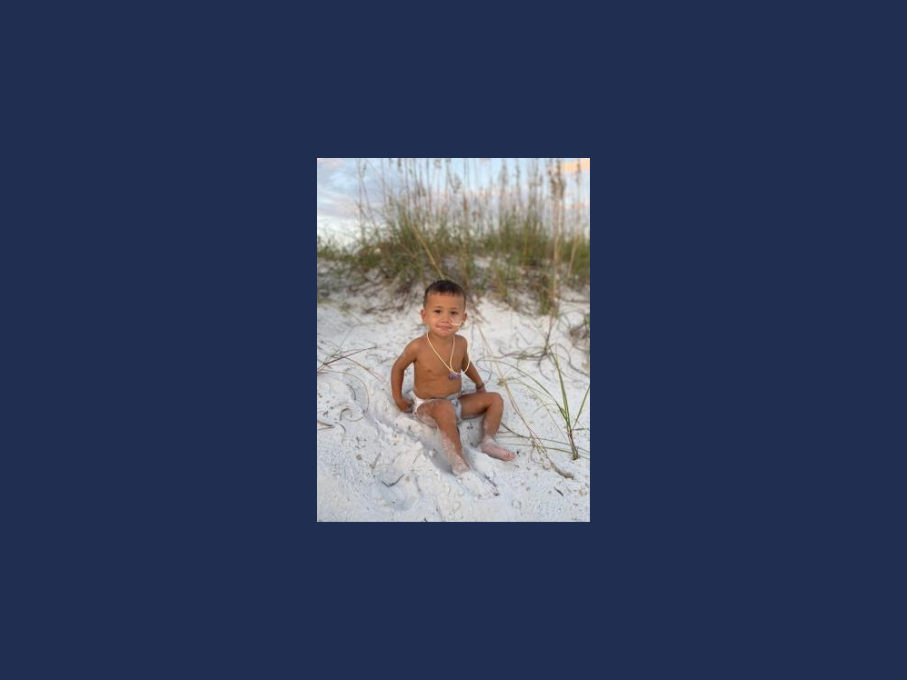 Toddler on white sand beach
