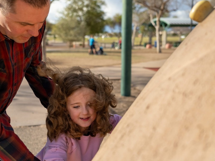 Girl & father on climbing rock