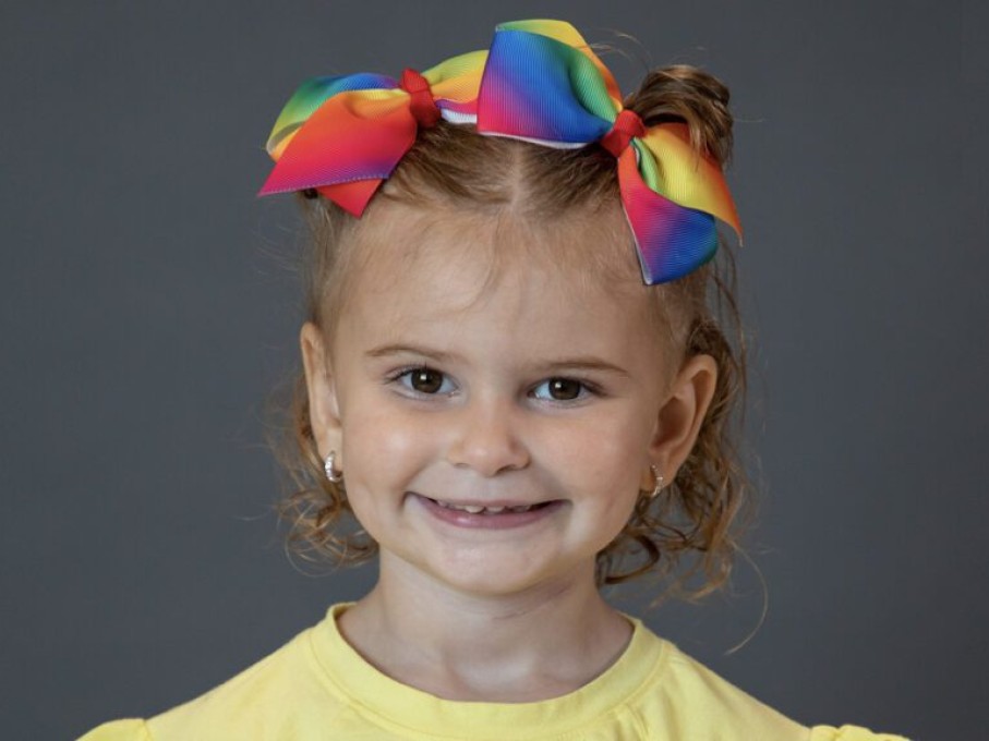 Young girl with color bows in hair
