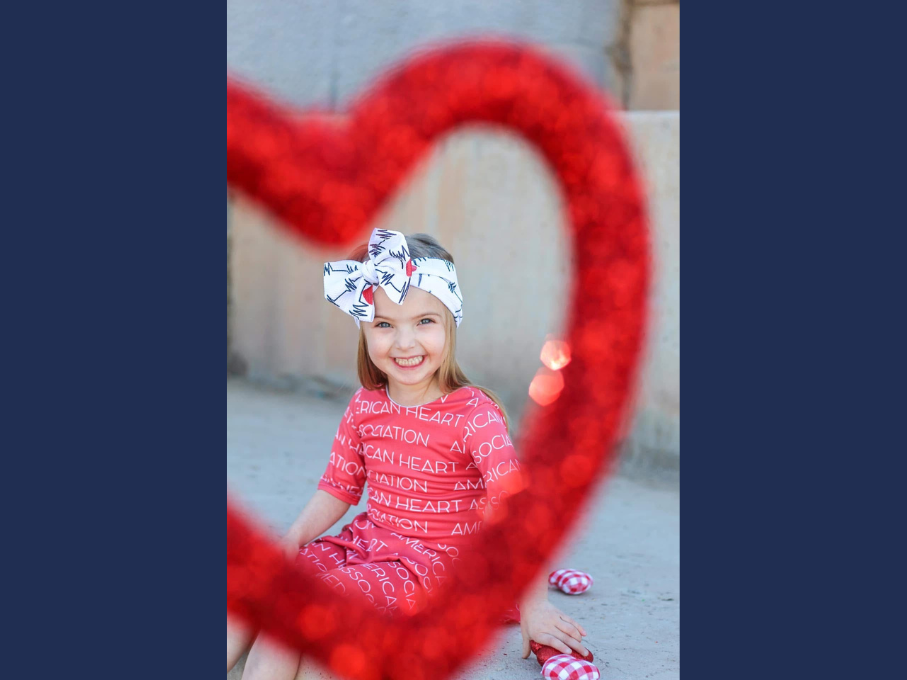 Girl smiling with read heart