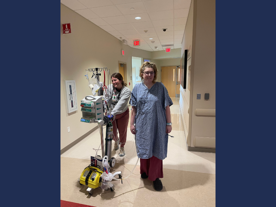 Teen in hospital gown posing with nurse