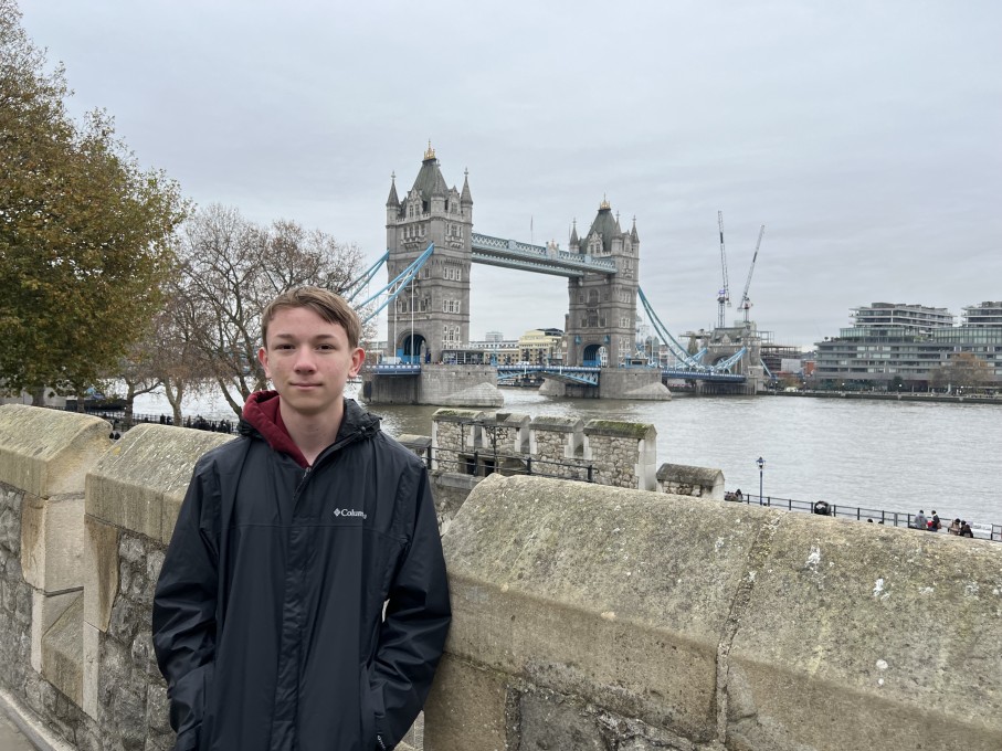 Teen boy posing near bridge