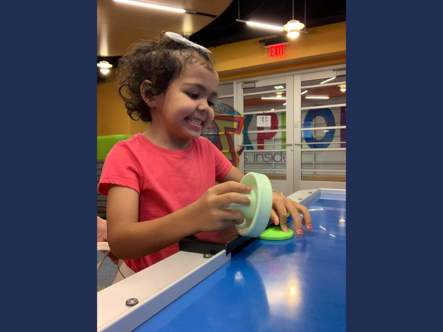 Girl playing air hockey
