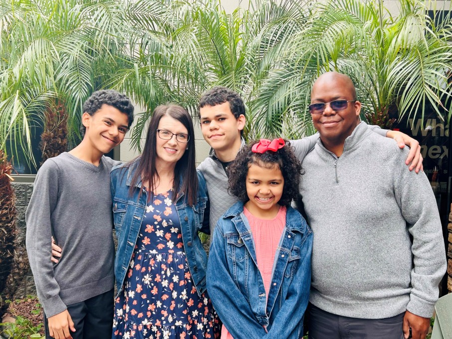 Family photo in front of palm trees