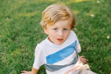 Boy sitting in grass