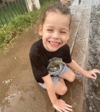 Toddler playing in the rain