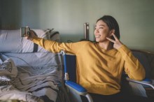 Teen girl in wheelchair taking a selfie