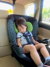 Sleeping child strapped in car seat