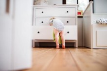 Toddler climbing into dresser drawer